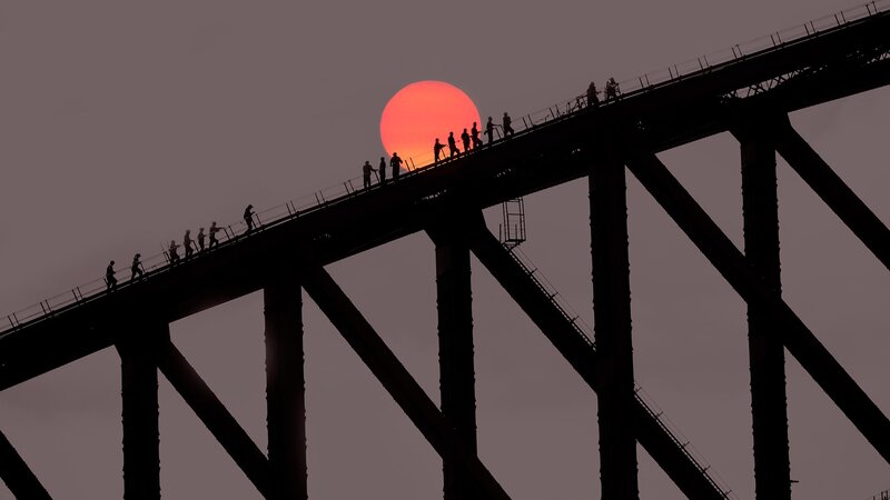 Silhouetted People on Bridge — Red