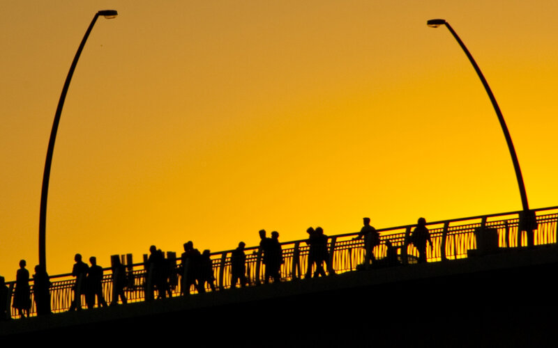 Silhouetted People on Bridge — Yellow, Dramatic