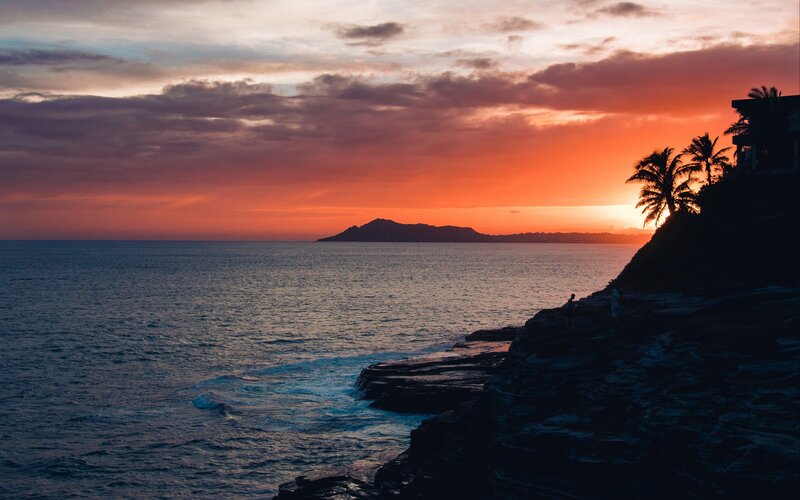 Silhouetted People on Cliff — Orange, Dramatic