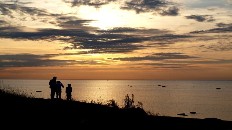 Silhouetted People on Cliff — Orange, Serene