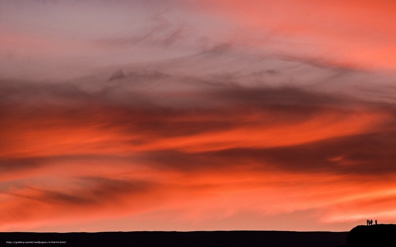 Silhouetted People on Cliff — Orange
