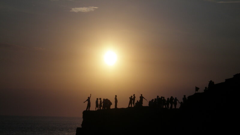Silhouetted People on Cliff