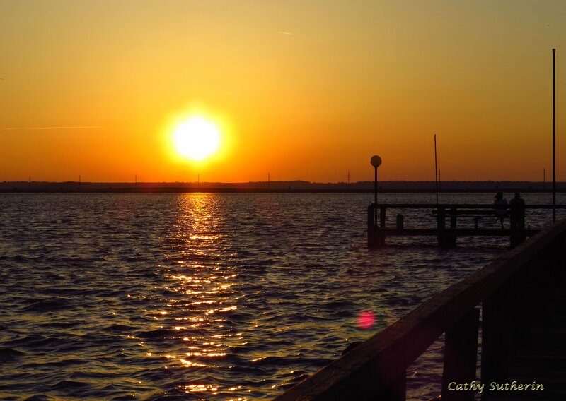 Silhouetted People on Dock — Orange, Serene, Sunset, Photograph