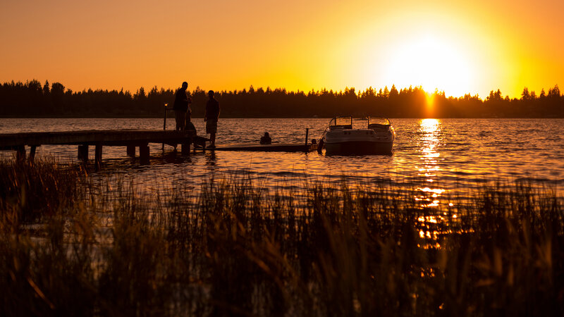 Silhouetted People on Dock — Orange, Serene, Sunset
