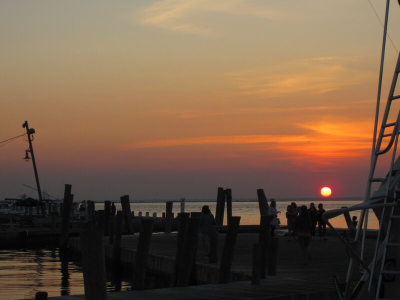 Silhouetted People on Dock — Orange