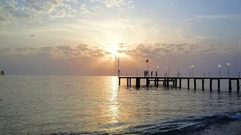 Silhouetted People on Pier — Blue, Serene, Sunset