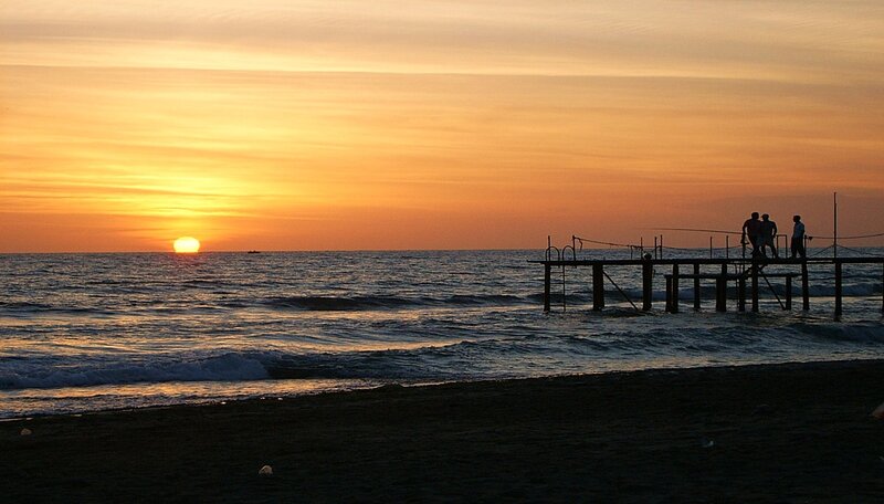 Silhouetted People on Pier — Orange, Serene, Sunset