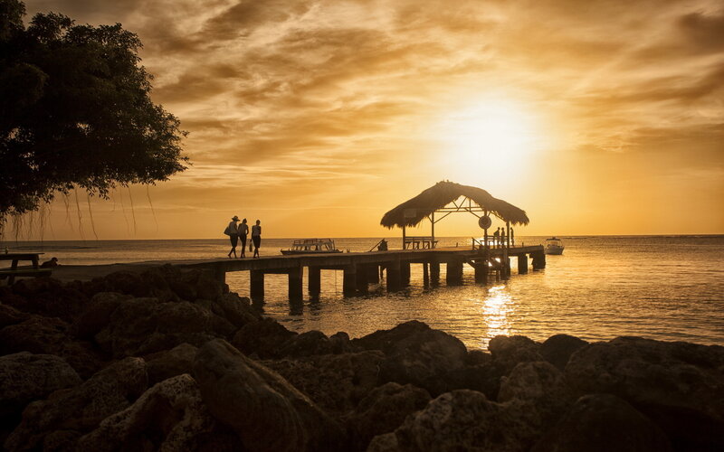 Silhouetted People on Pier — Orange, Serene