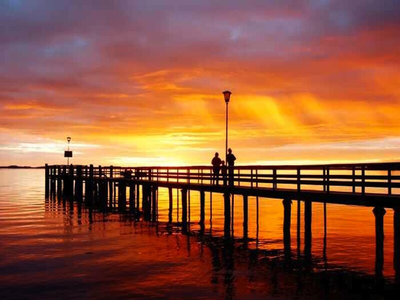 Silhouetted People on Pier — Orange