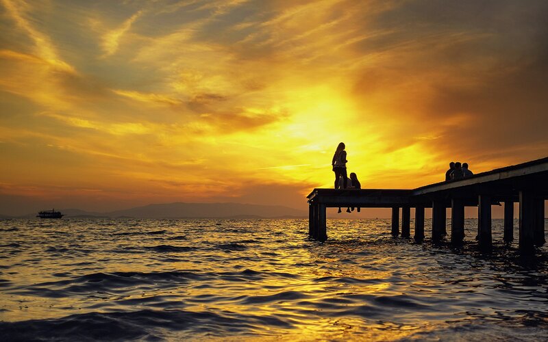 Silhouetted People on Pier — Yellow