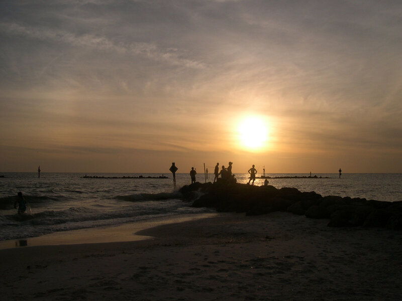 Silhouetted People on Rocks — Yellow