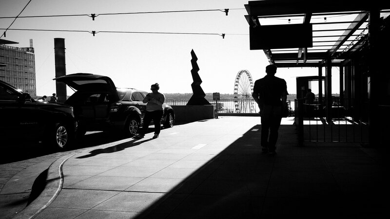 Silhouetted People on Sidewalk