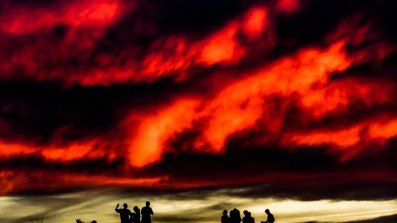 Silhouetted People Watching Sky — Red