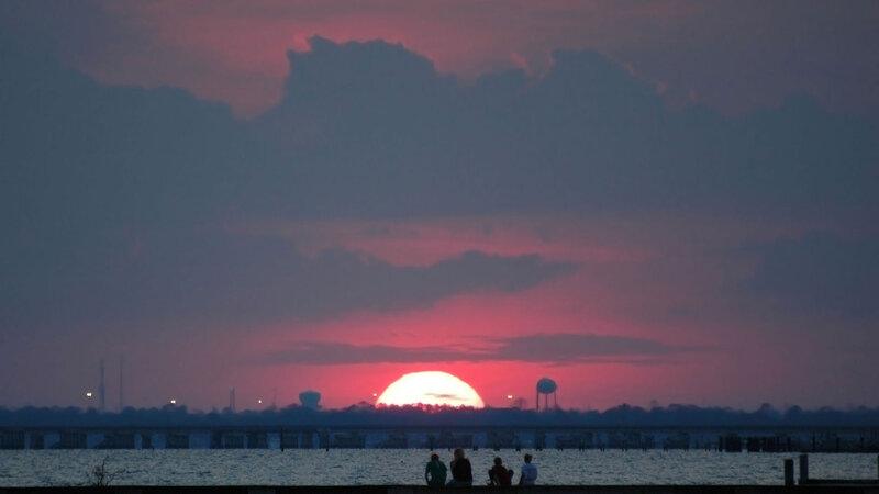 Silhouetted People Watching Sunset — Red