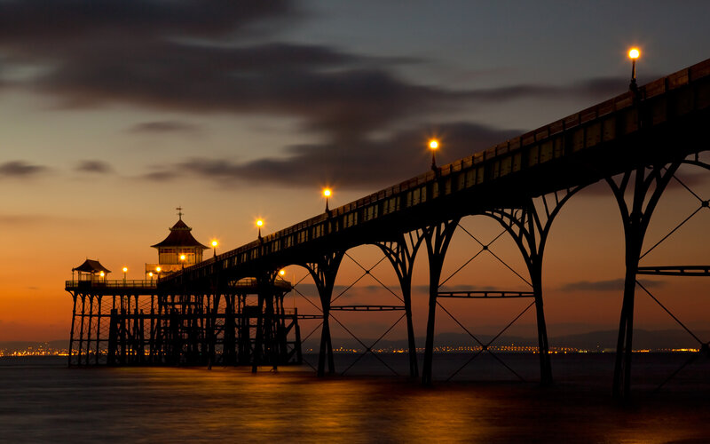 Silhouetted Pier at Dusk — Orange