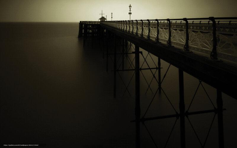 Silhouetted pier at dusk