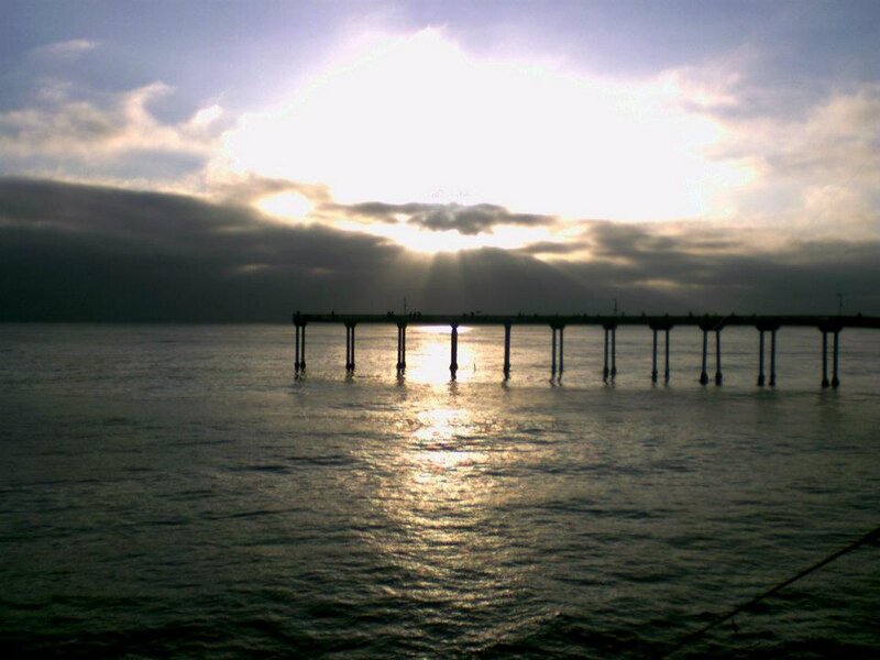 Silhouetted Pier at Sunset — Gray