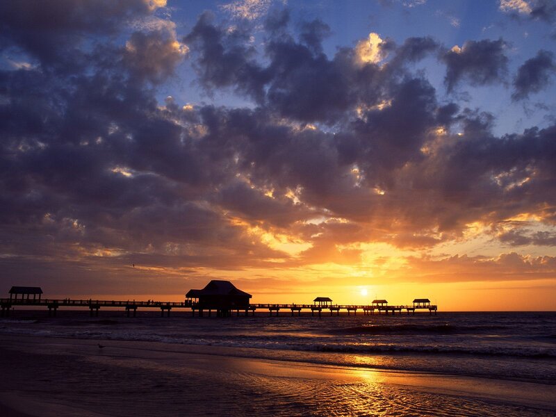 Silhouetted Pier at Sunset — Orange, Dramatic, Photograph, Ocean, Clouds, Sun, Blue