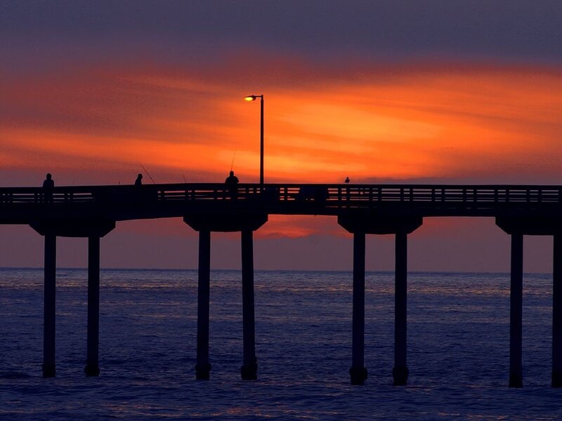 Silhouetted Pier at Sunset — Orange, Serene