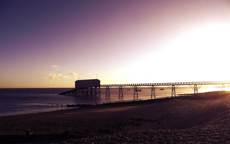 Silhouetted Pier at Sunset — Purple, Serene