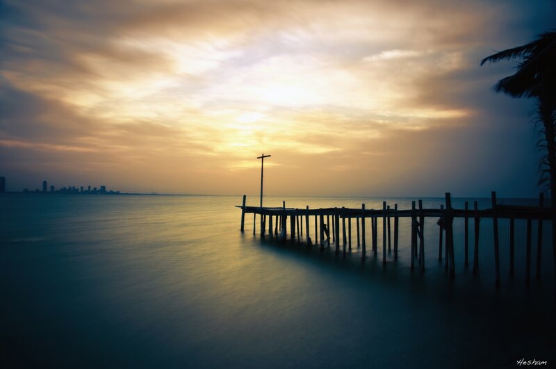 Silhouetted Pier at Sunset — Yellow, Serene, Photograph, City Skyline