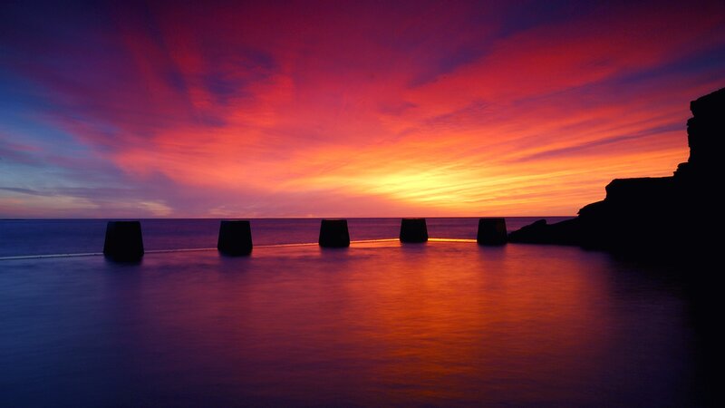 Silhouetted Pillars at Sunset — Red, Dramatic