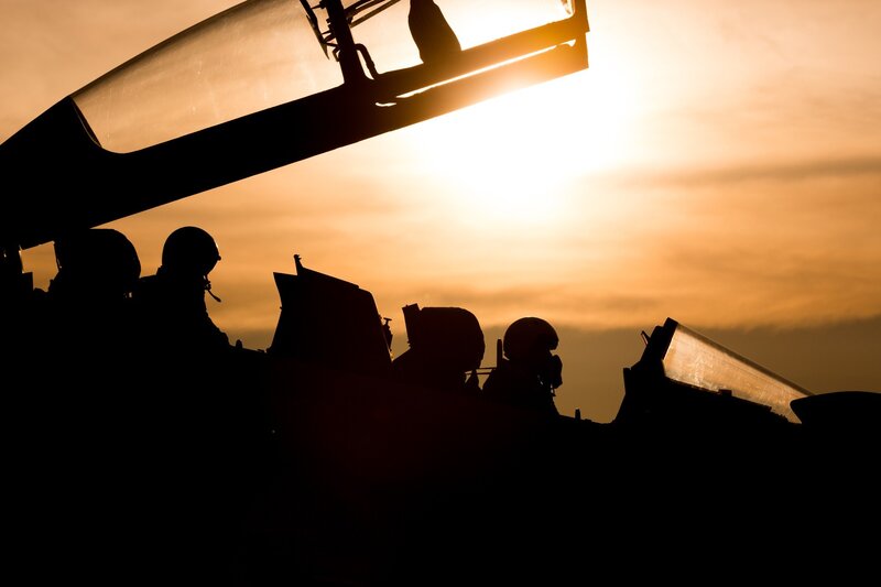 Silhouetted Pilots in Cockpit