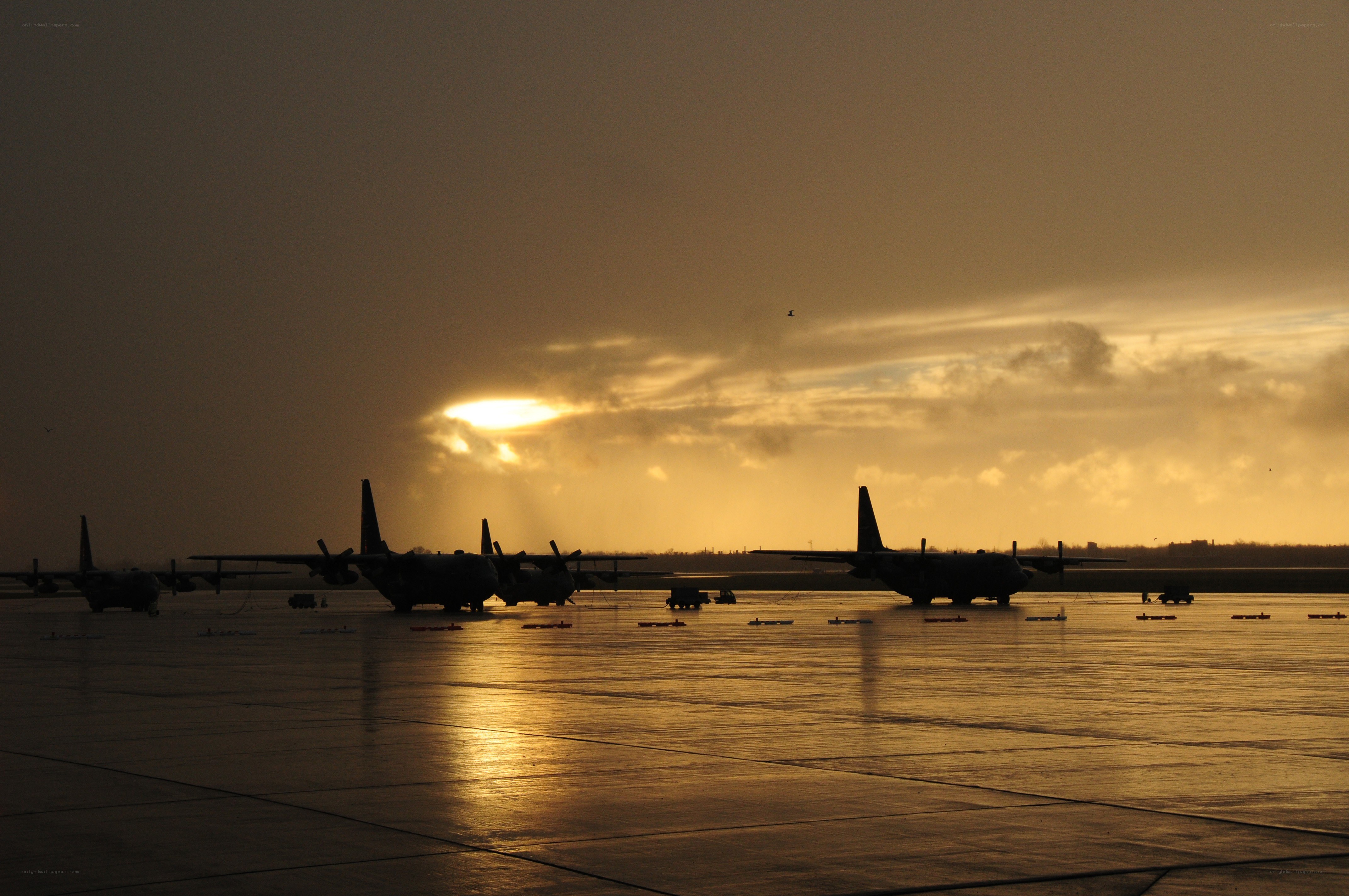 Silhouetted planes at sunset