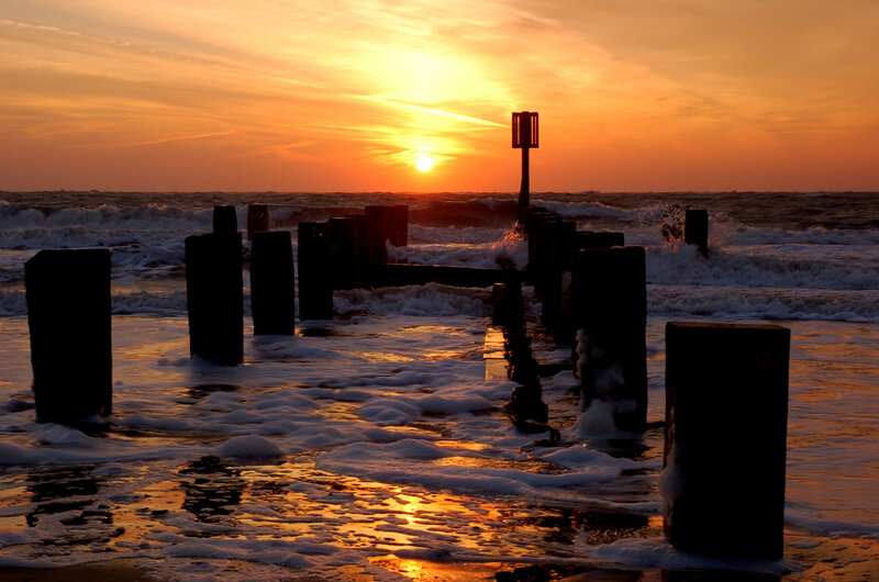 Silhouetted Posts at Sunset — Orange, Dramatic