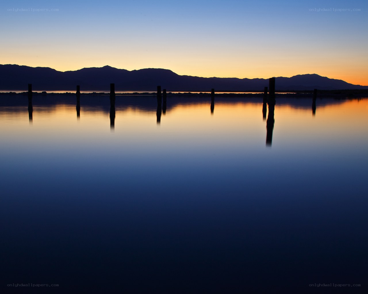Silhouetted posts at sunset