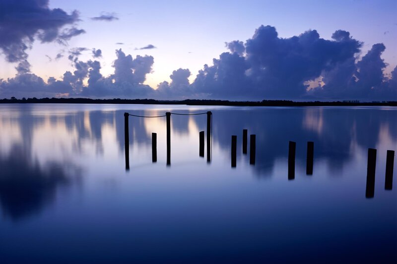 Silhouetted Posts in Water — Blue