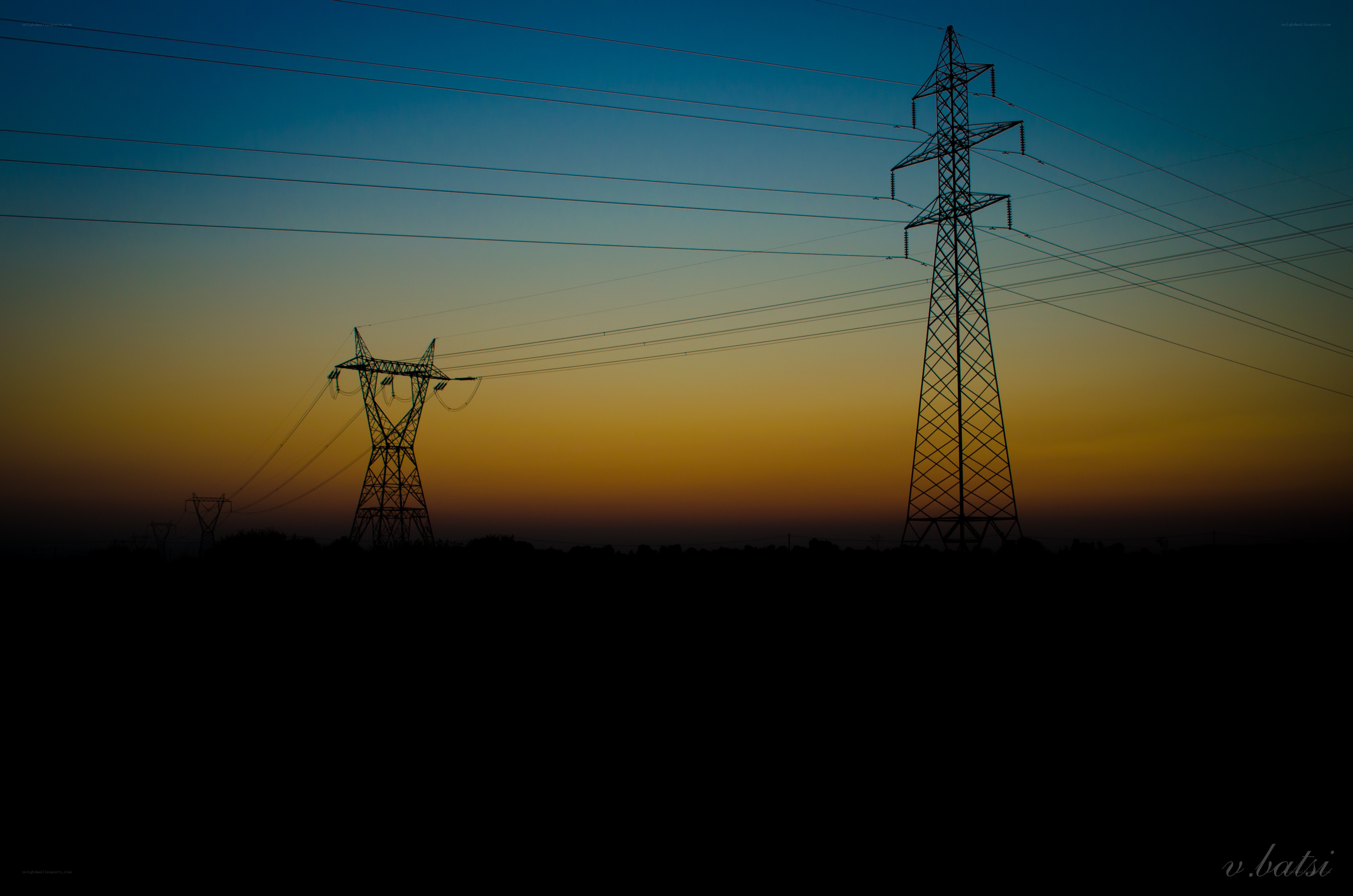 Silhouetted power lines at dusk