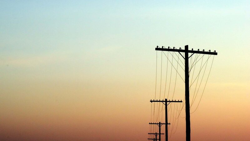 silhouetted power lines at sunset