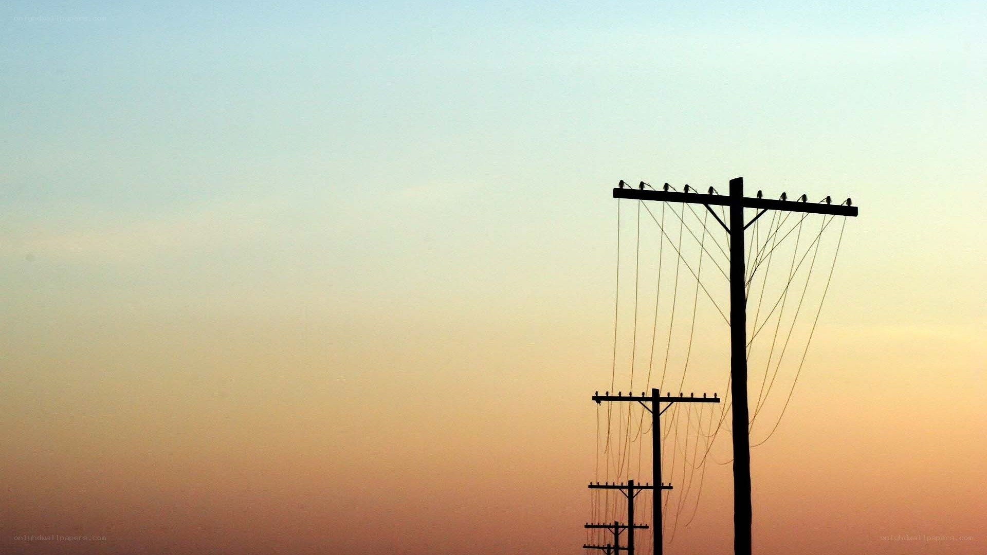 silhouetted power lines at sunset