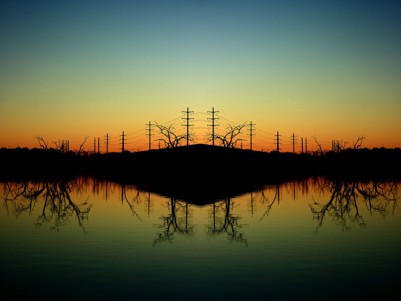 Silhouetted power lines at sunset