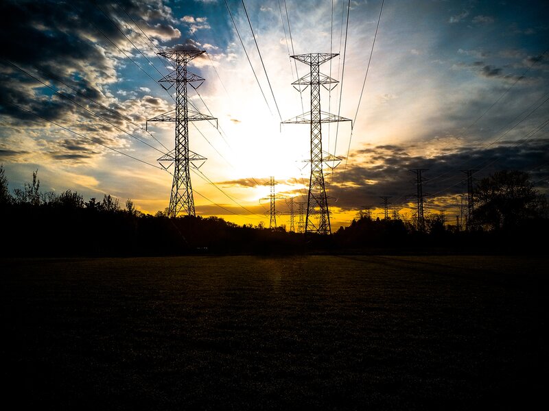 Silhouetted power lines at sunset