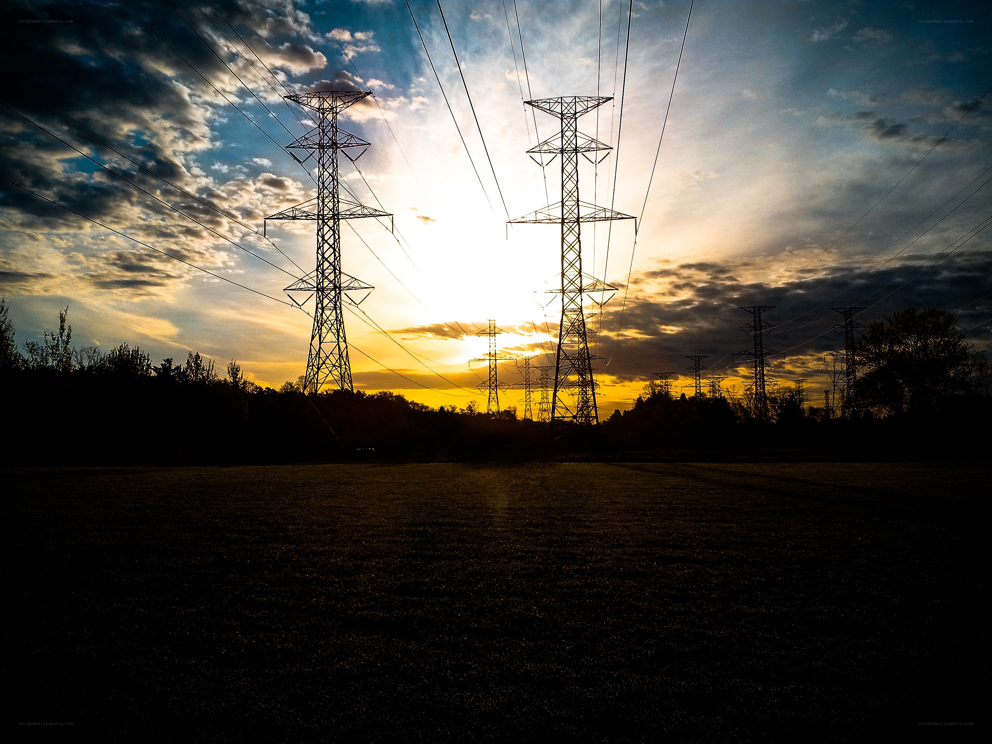 Silhouetted power lines at sunset