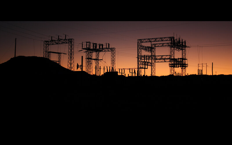 Silhouetted power station at sunset