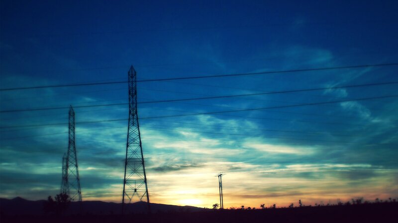 Silhouetted Power Towers — Blue, Dramatic, Sunset