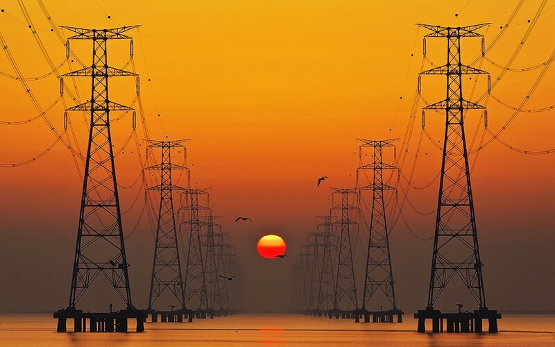Silhouetted Power Towers — Orange, Dramatic