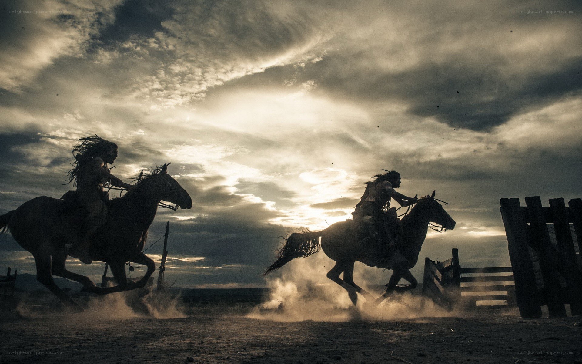 Silhouetted riders at sunset