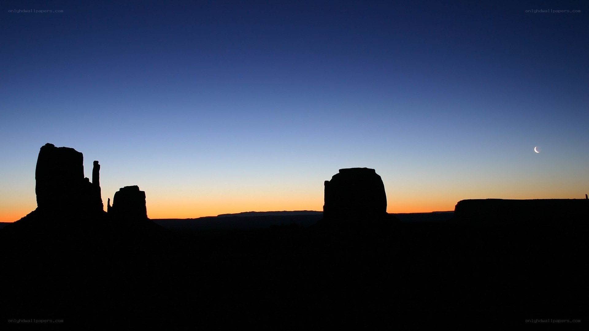 silhouetted rock formations at dusk