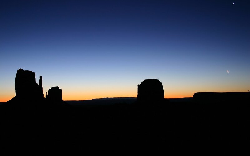 silhouetted rock formations at dusk