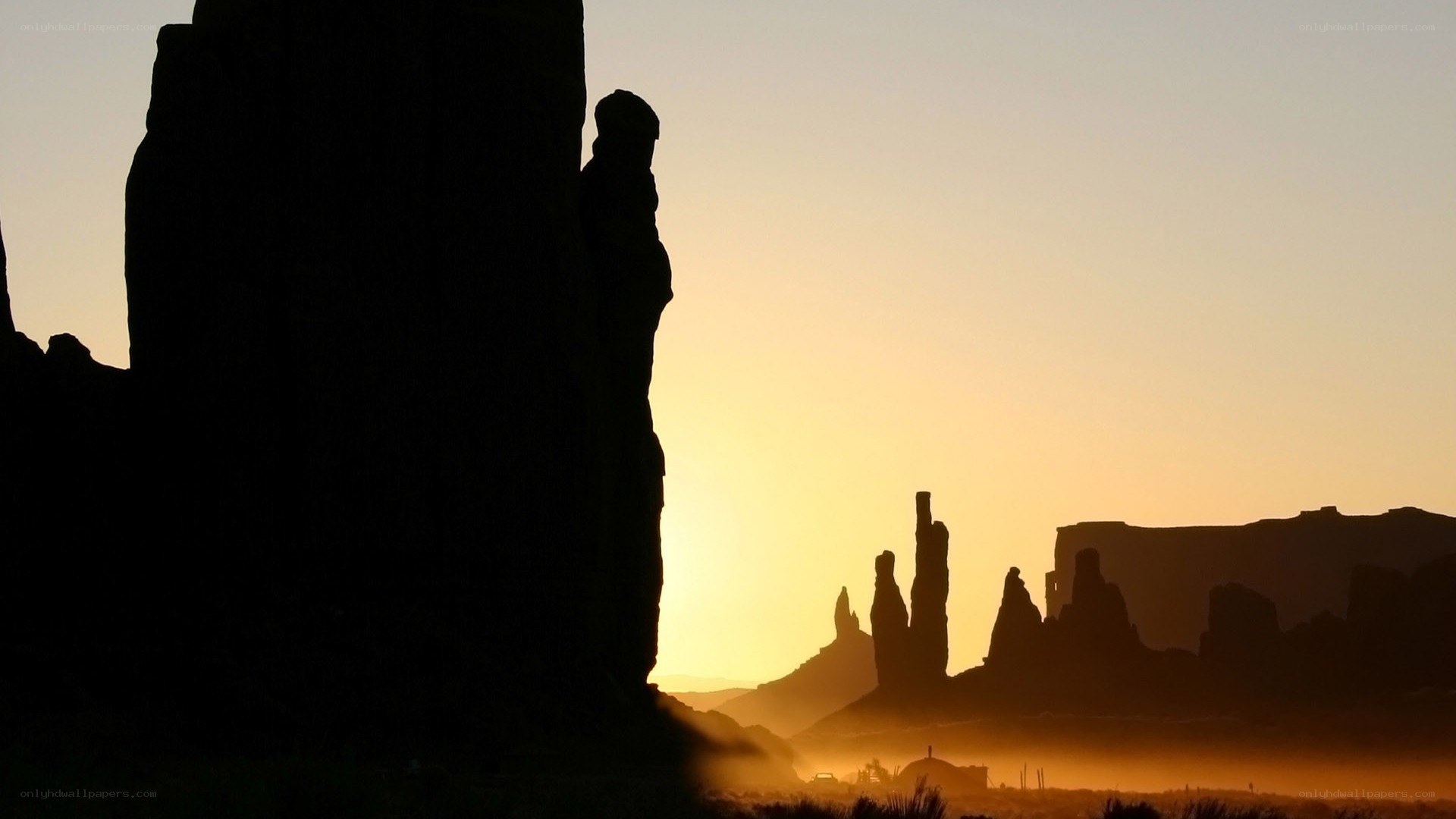 silhouetted rock formations at sunrise