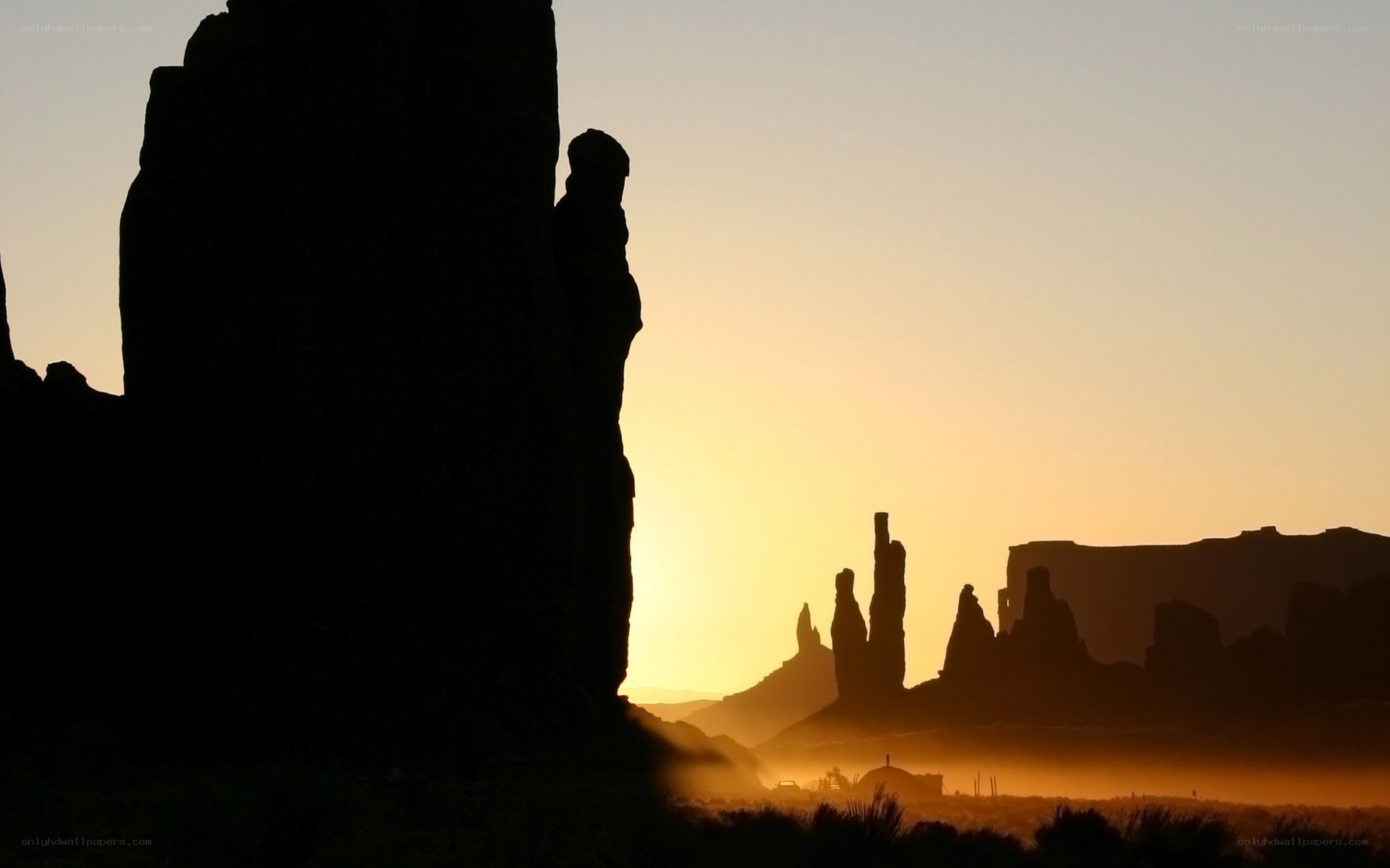 silhouetted rock formations at sunrise
