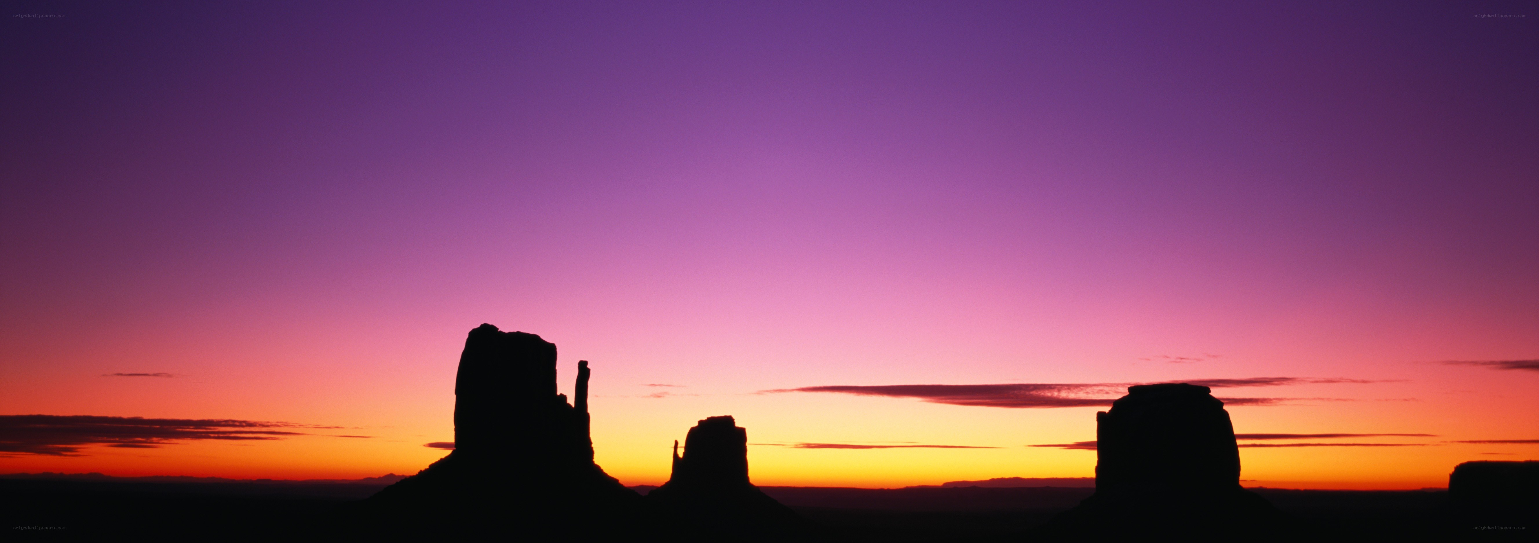 silhouetted rock formations at sunset