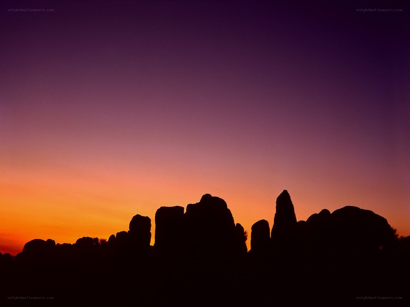 Silhouetted rock formations at sunset