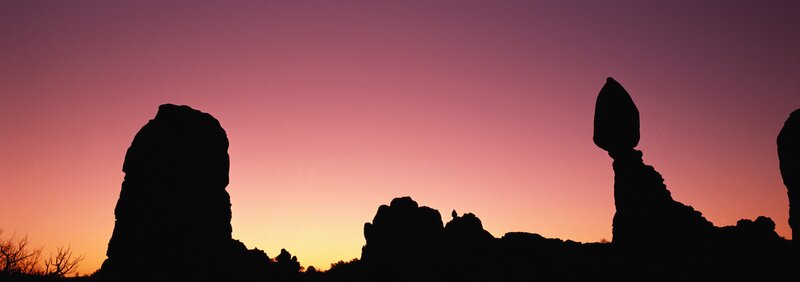 silhouetted rock formations at sunset