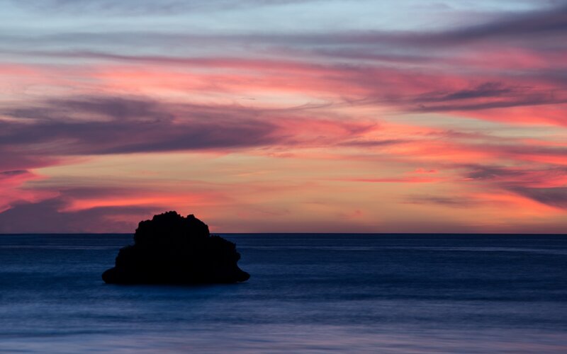 Silhouetted Rock in Ocean
