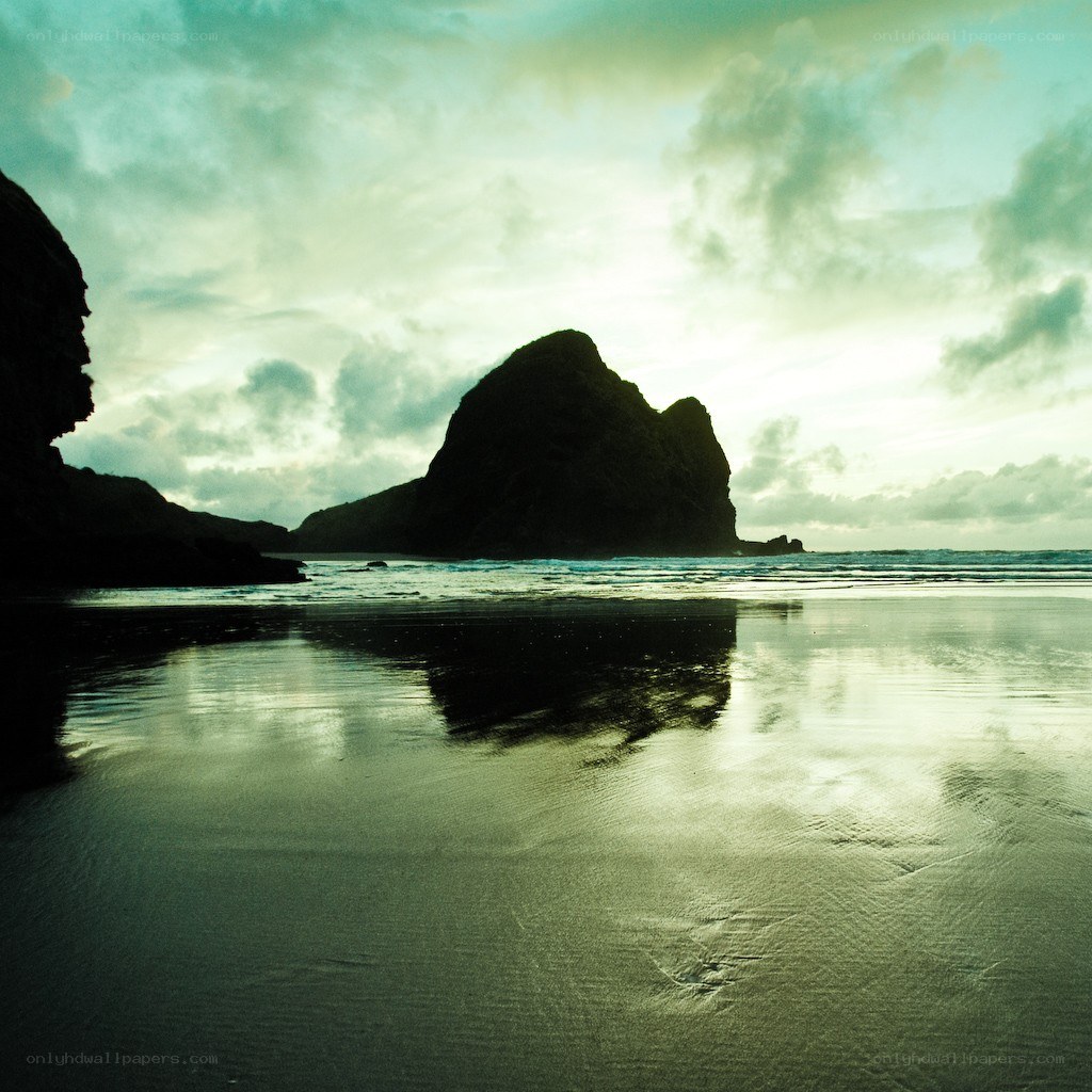 silhouetted rocks at beach